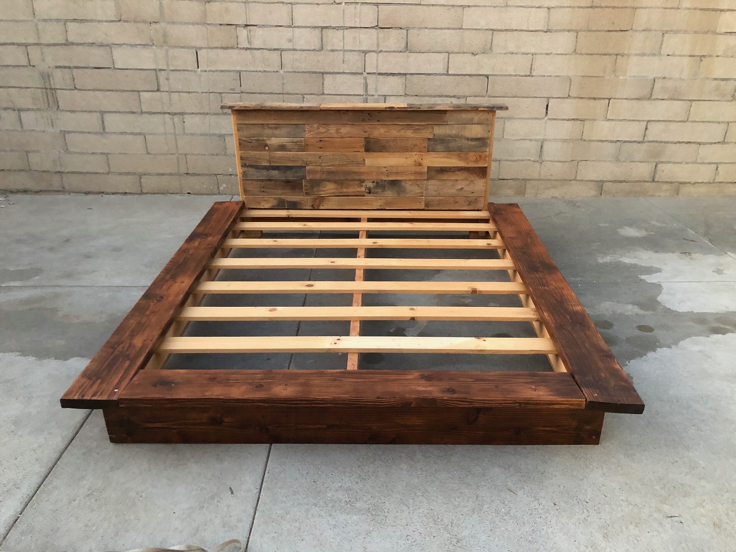 A Rustic Platform Bed with a Reclaimed Wood Patchwork Headboard